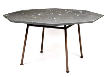 A vintage patio table with an octagonal