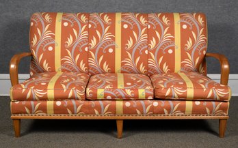 A mid-century sofa with with maple