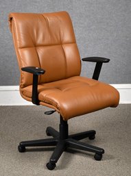 A brown leather swiveling, rolling,