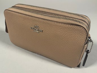 A Coach Kira crossbody in taupe