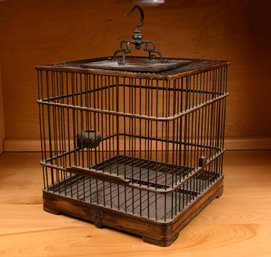 A vintage Chinese wood and brass birdcage,