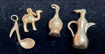 Two 18k yellow gold charms, ewer