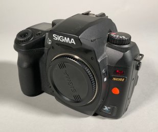 A Sigma SD camera body with lens cap,