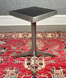 A small aluminum side table with