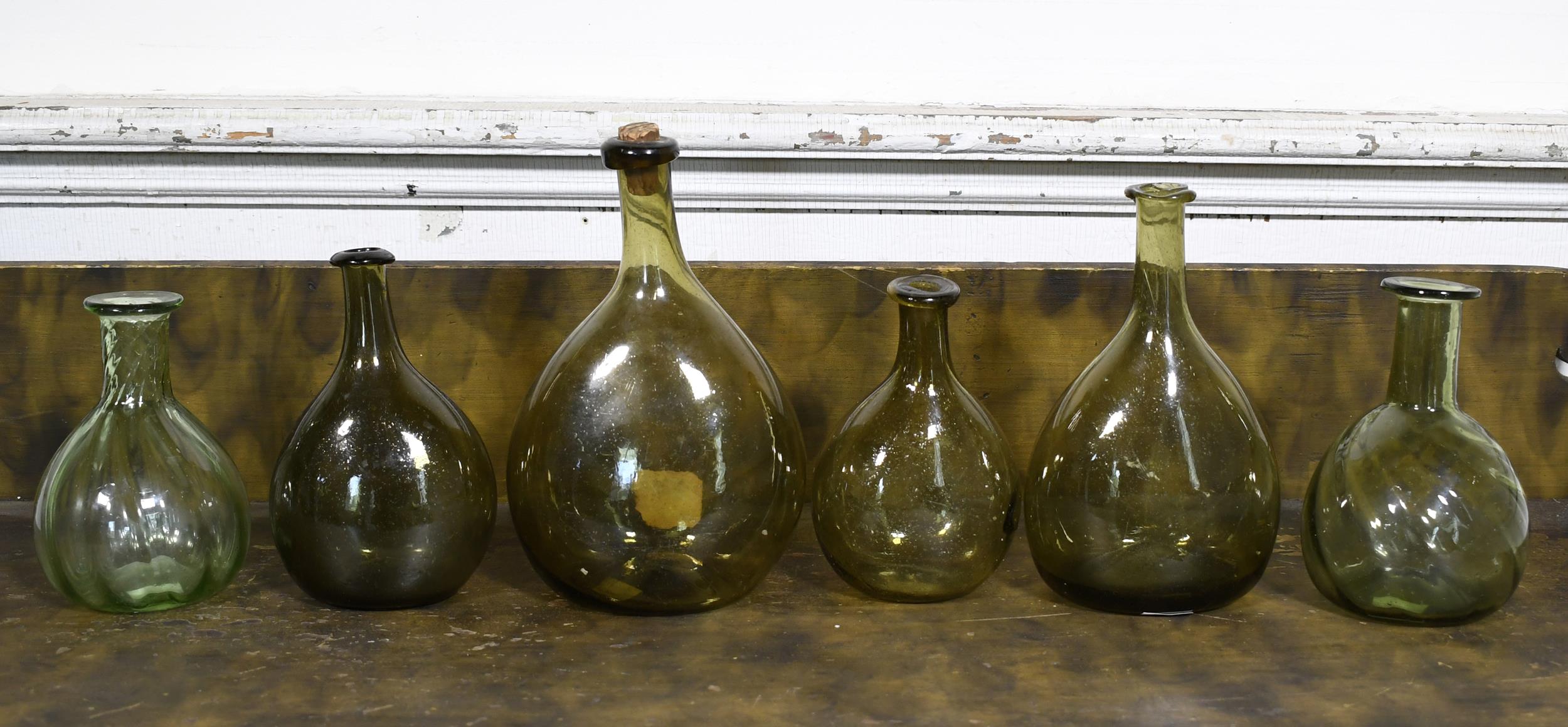 SIX ANTIQUE CHESTNUT AND OTHER BOTTLES.