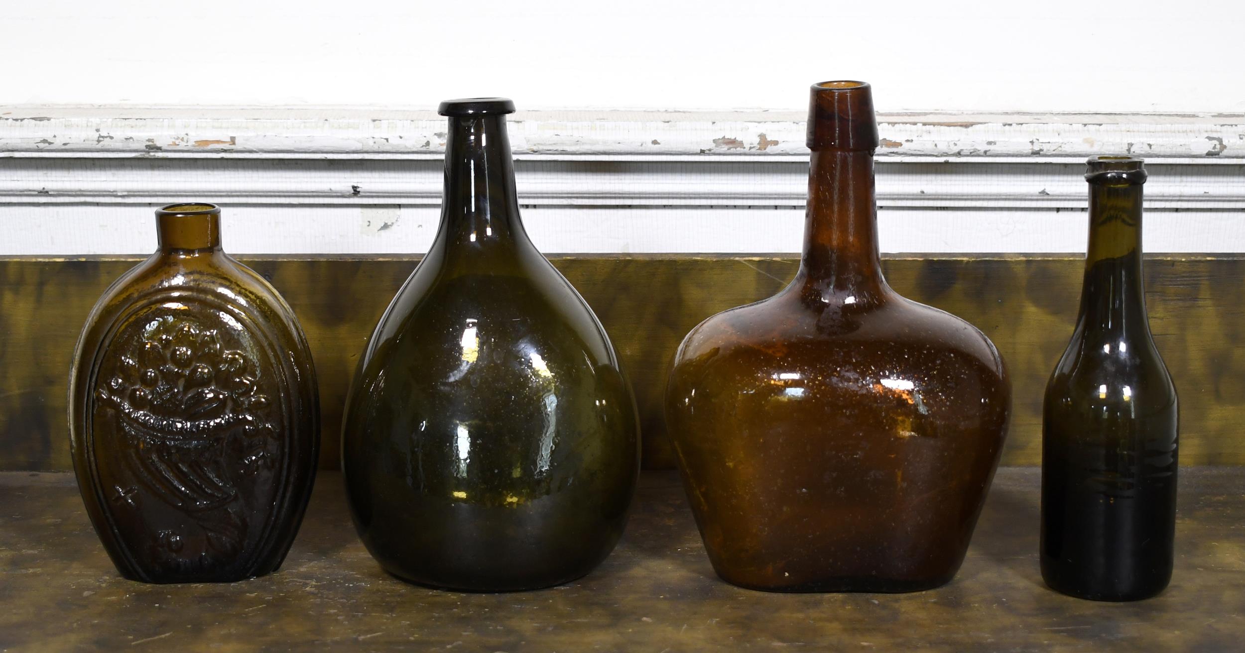 19TH C. FLASK AND THREE BOTTLES. Amber-brown