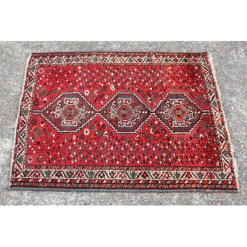 Old handwoven wool carpet of red