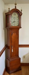 An antique cherry grandfather clock