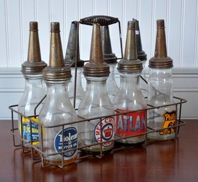 Eight glass quart sized oil bottles