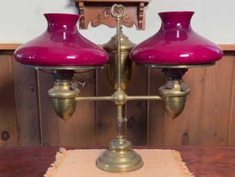 An antique brass double student lamp