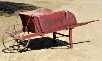 Antique red painted wooden wheel barrow,