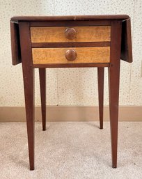 An antique two drawer drop leaf