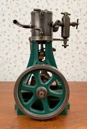 Antique steam engine toy in green metal.