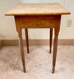 An antique birdseye maple stand