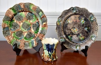 Two antique majolica plates in black,