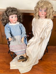 Two bisque head dolls in matching