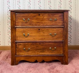 A small antique cottage pine three-drawer