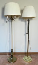 Two modern brass floor lamps, one