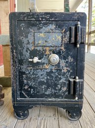 Antique small iron safe on caster feet,