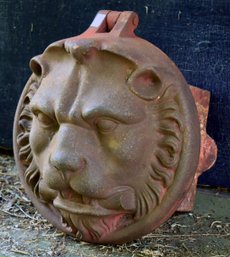 A vintage cast iron lion head architectural