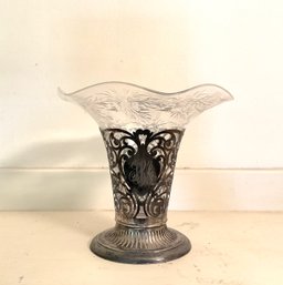 A floral etched ruffled glass insert,