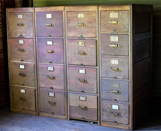 A vintage four-part oak file cabinet