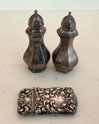 A pair of 3"H salt shakers marked