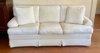 A sleeper(queen) sofa in white upholstery,