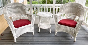 Two vintage white wicker armchairs