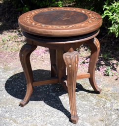 A vintage mahogany swiveling piano stool,