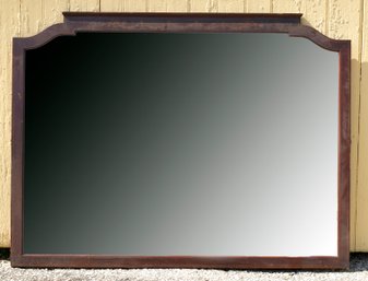 A vintage mahogany wall mirror with