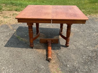 A ca. 1890 oak table with a square