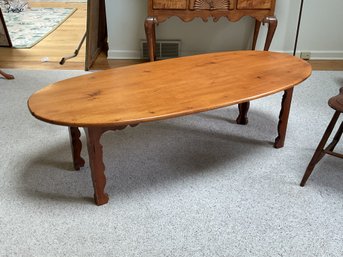 A vintage bench made pine oval coffee