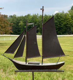 A vintage copper sailboat weathervane.