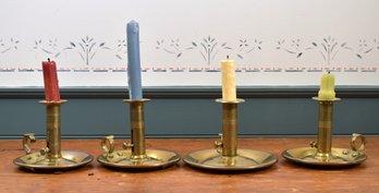 Four antique brass chambersticks