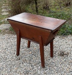 An antique pine dough box on legs,