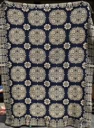 An antique blue and white homespun coverlet,