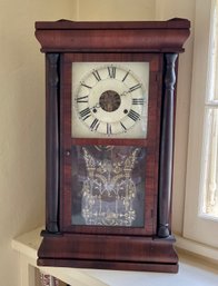 An antique rosewood shelf clock,