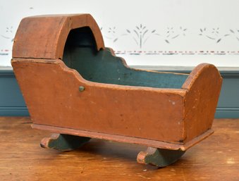 A painted doll cradle from the