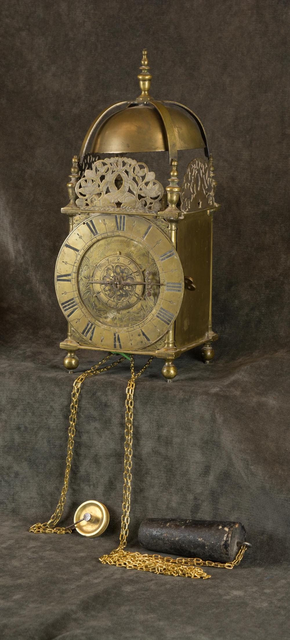 AN ENGLISH BRASS STRIKING LANTERN CLOCK