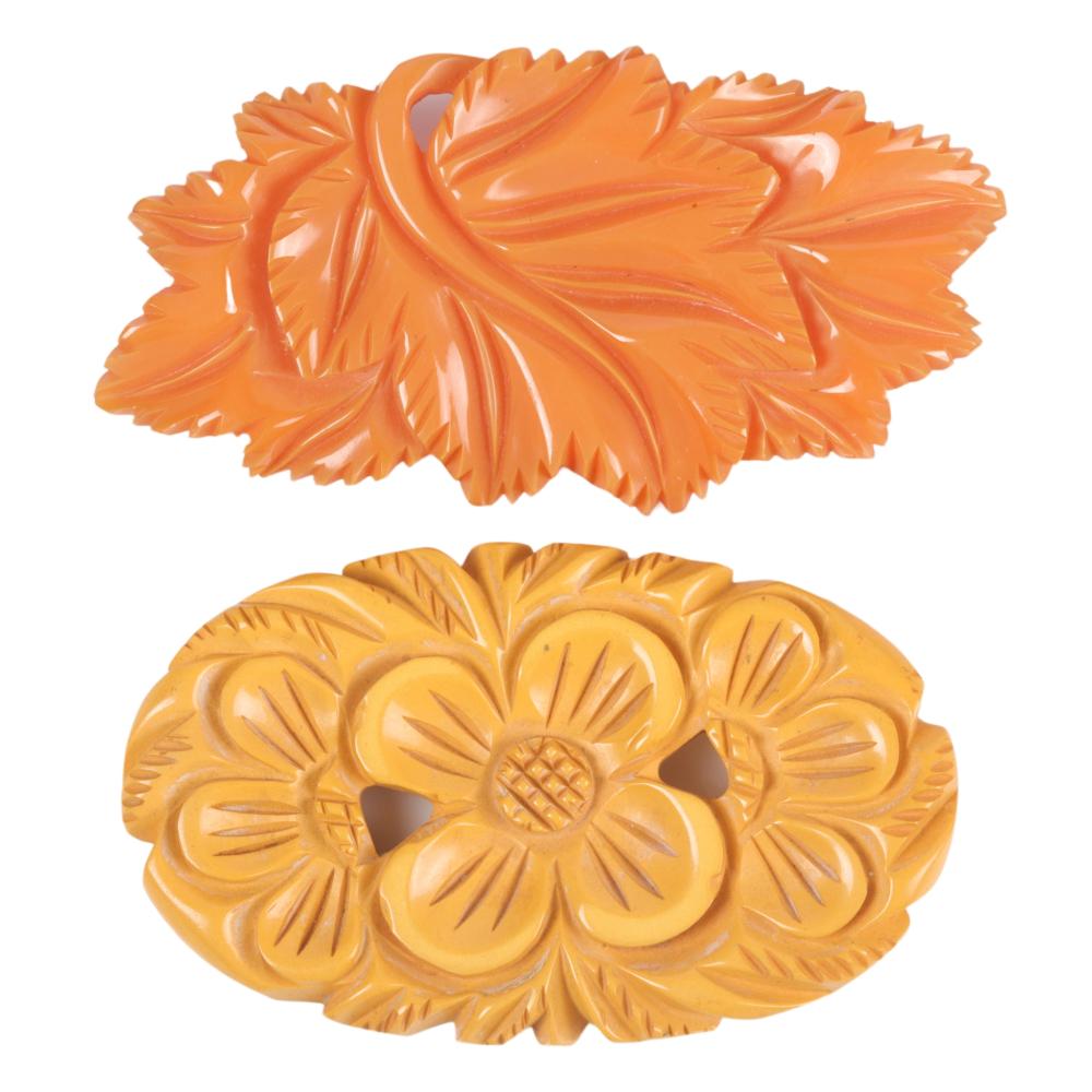 TWO BAKELITE PINS, CREAM AND ORANGE.