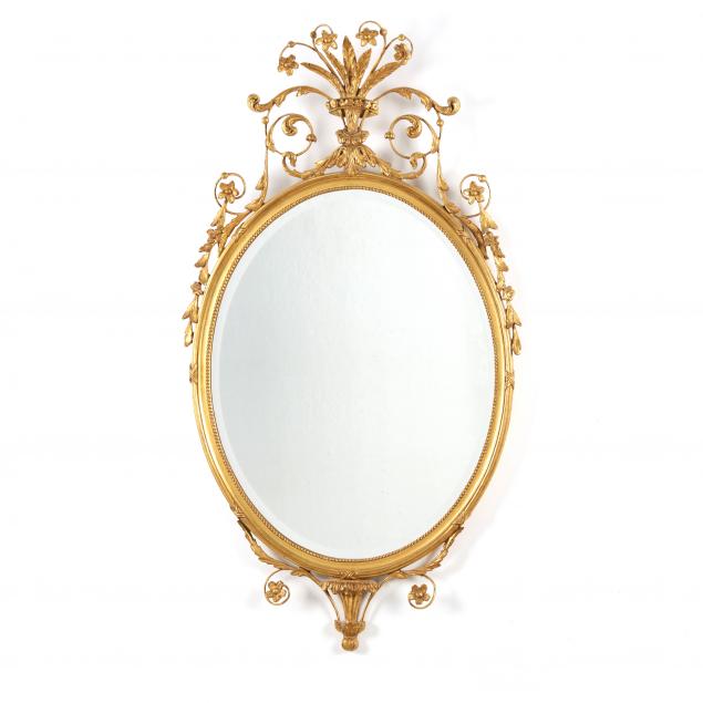 AN ADAM STYLE OVAL GILTWOOD MIRROR