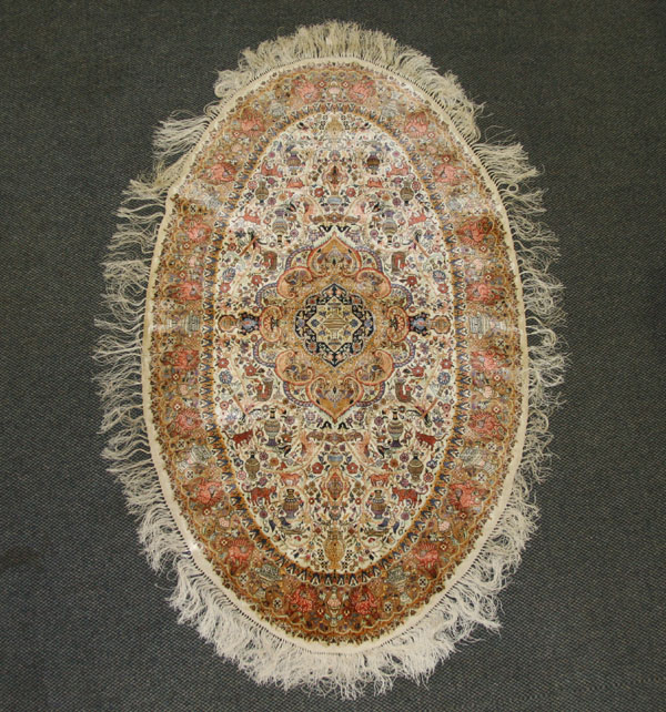 Hand woven silk oriental rug; oval