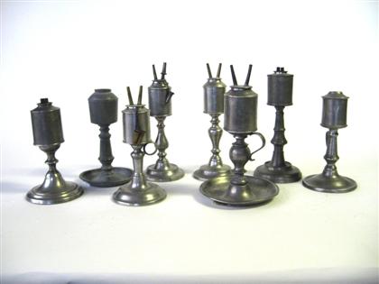 Eight pewter cylinder fonted lamps 4da59