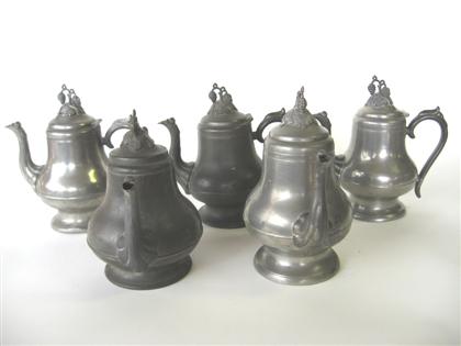Group of five pewter teapots with