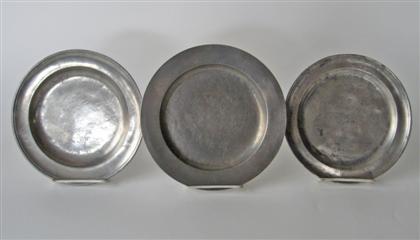 Three pewter plates with molded 4da90