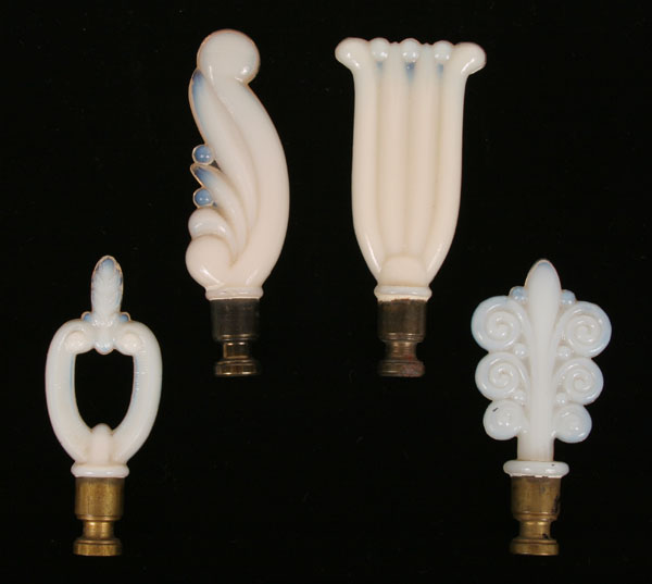 Four opaque Aladdin lamp finials;