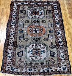An antique Oriental area rug with