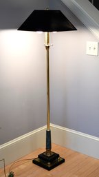 A modern brass floor lamp with