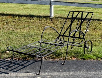 A vintage wrought iron chaise lounge